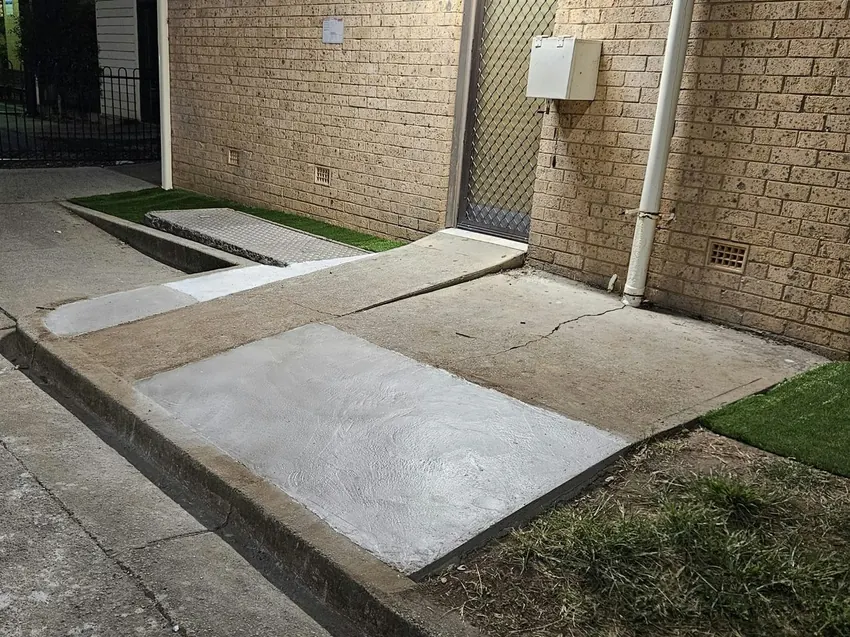 Freshly patched concrete pathway at a Smithfield strata property.