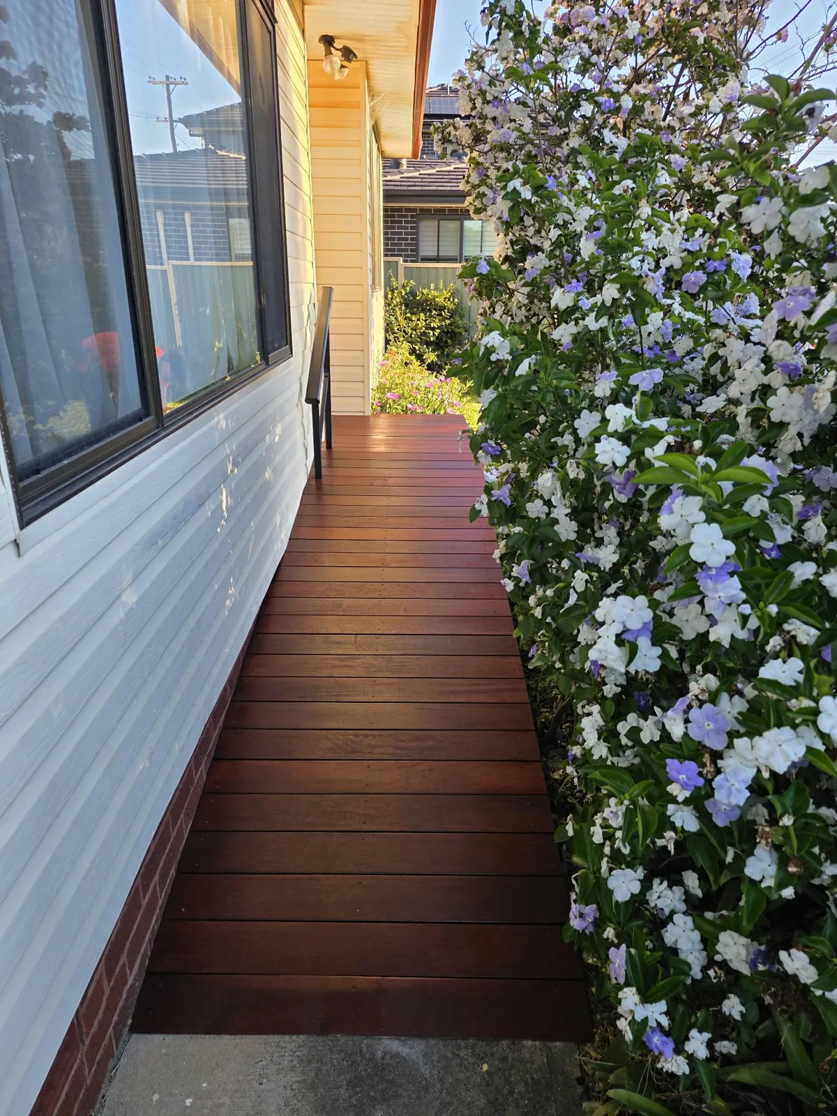 Custom Accessibility Ramp: Before & After: stepped entry replaced with a custom timber ramp and handrail for step-free access