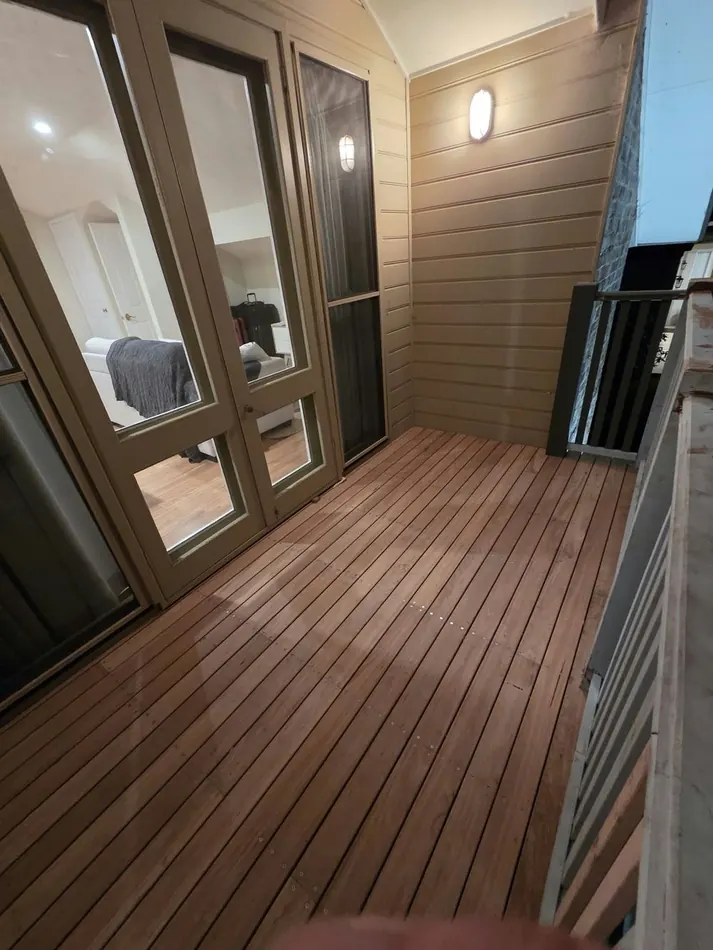 Restored balcony decking and railing after the job