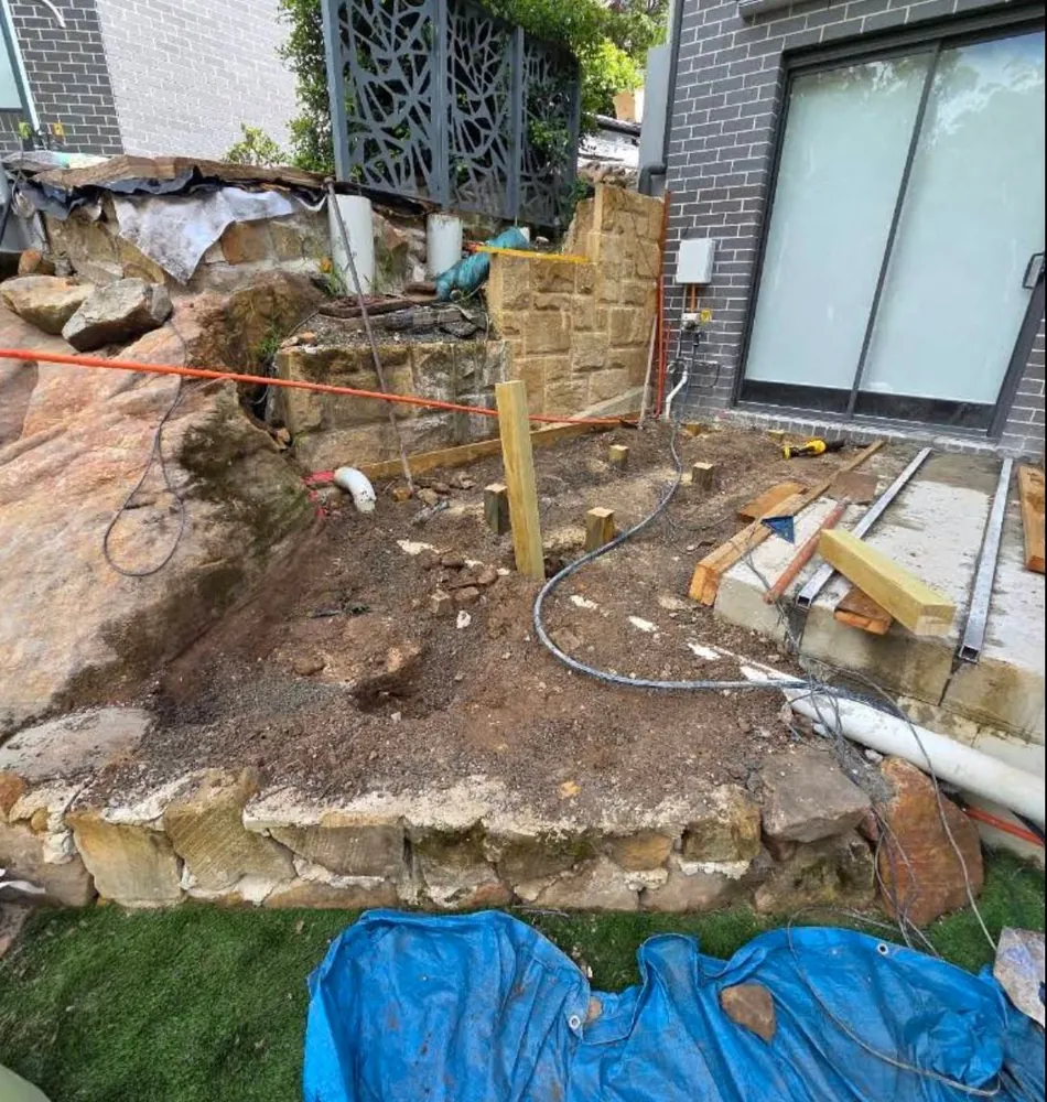 Backyard before excavation, raw dirt and rock