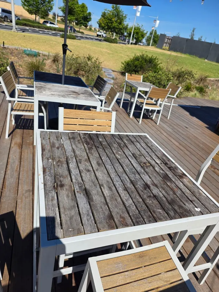 Weathered outdoor tabletop before restoration