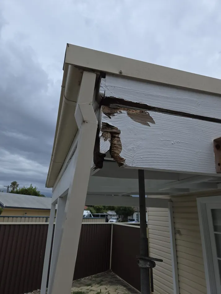 Rotten patio fascia board before repair