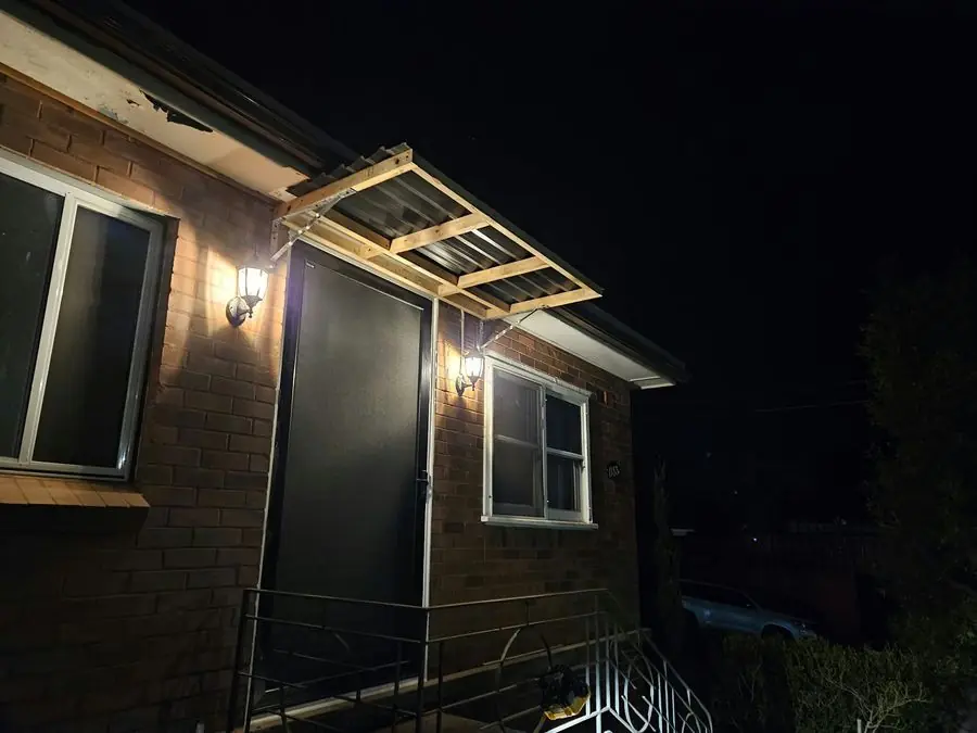 Front Door Awning: new timber-framed awning over the front entry