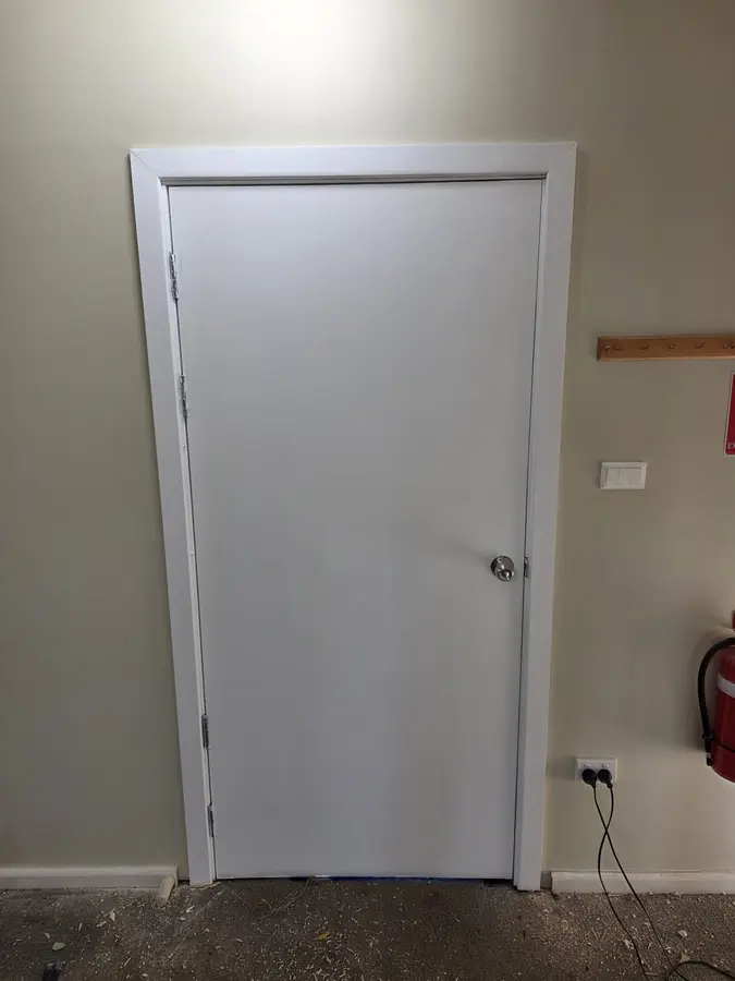 External Door & Frame Installation: new door and frame fitted into an existing brick opening
